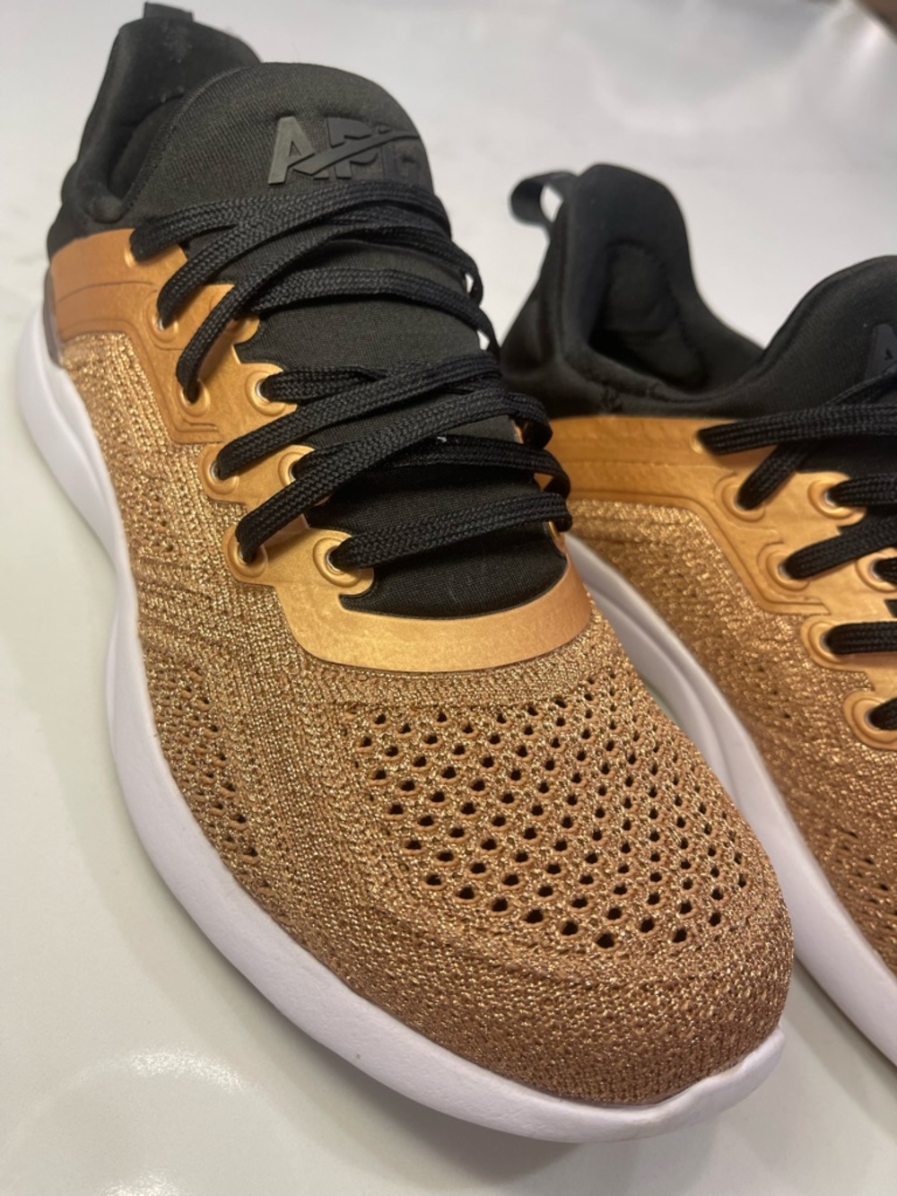 APL TechLoom Tracer women's sneakers in a rose gold and black knit colorway